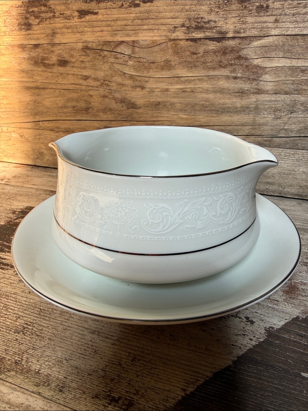 American Limoges White Porcelain Gravy Boat with Silver Trim and attached plate.